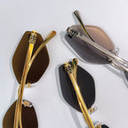 MiuMiu glasses closeup with gold and silver frames and embossed temple details