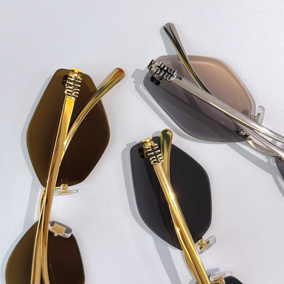 MiuMiu glasses closeup with gold and silver frames and embossed temple details