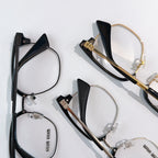 MiuMiu eyeglasses assortment with black and gold-tone frames, clear lenses