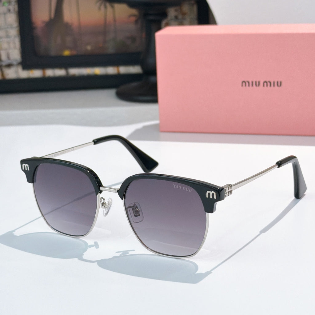 Sunglasses with dark lenses and black acetate frame, gold-toned hinges, logo detail on temples