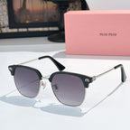 Sunglasses with dark lenses and black acetate frame, gold-toned hinges, logo detail on temples