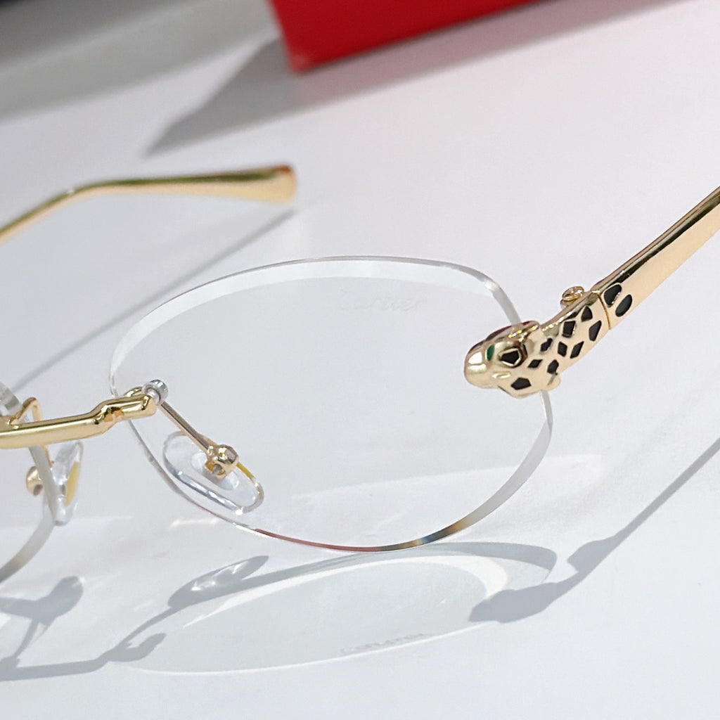 Cartier round eyeglasses close-up with gold frame, clear lens, leopard temple detail.