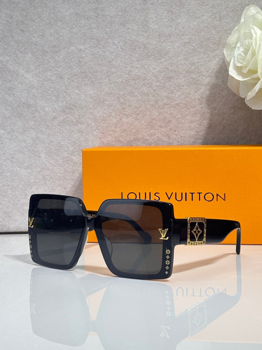 Louis Vuitton square sunglasses, dark blue frames, tinted lenses, LV logo on temples