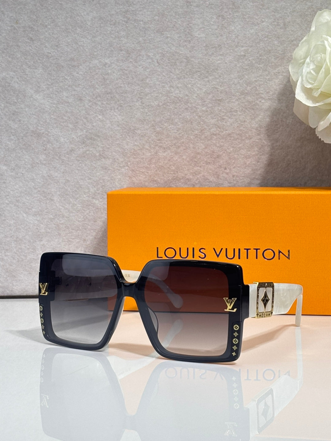 Louis Vuitton square sunglasses, navy frames, tinted lenses, LV logo detail on temples