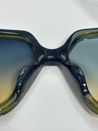 Louis Vuitton sunglasses close view, glossy dark frames with tinted lenses