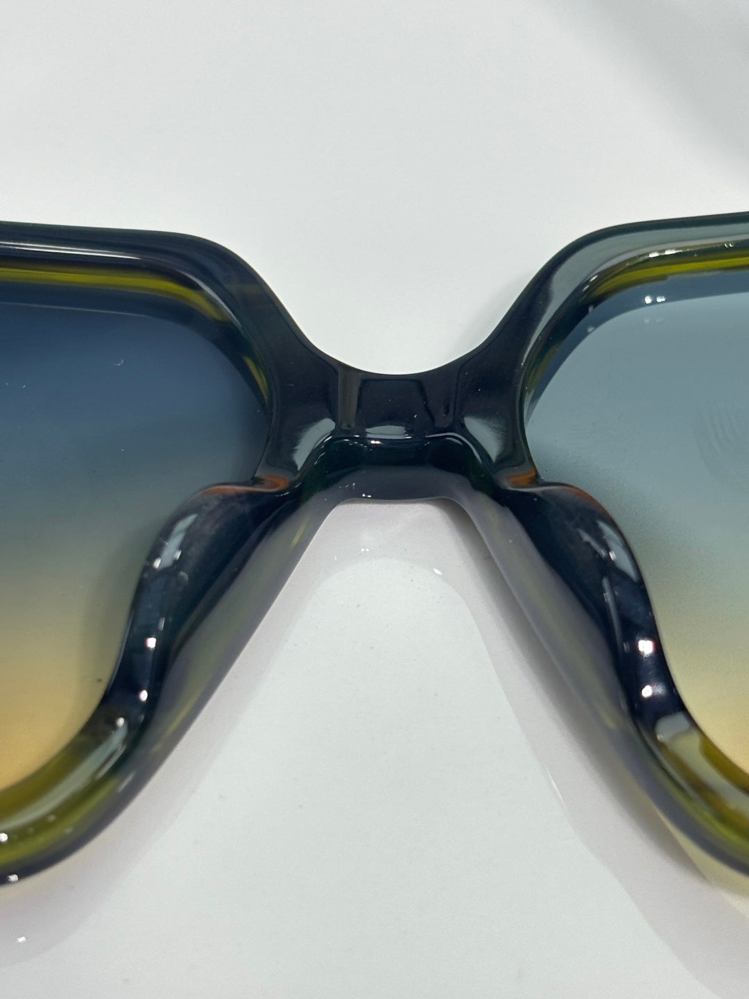 Louis Vuitton sunglasses close view, glossy dark frames with tinted lenses