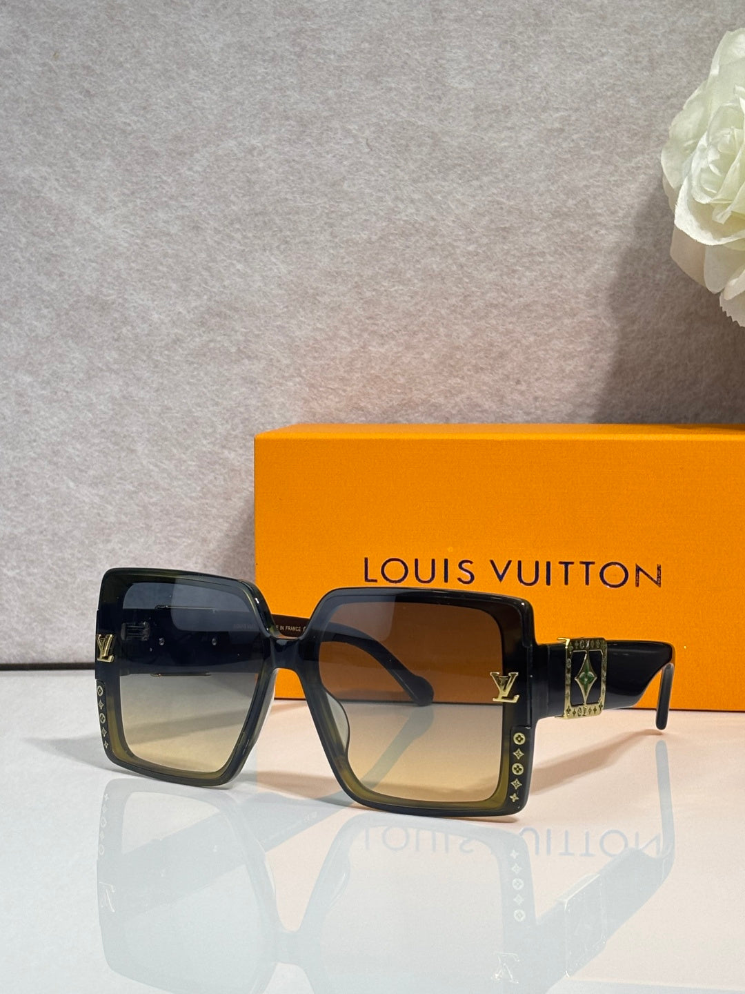 Louis Vuitton square sunglasses, black frames, tinted lenses, LV logo detail on side