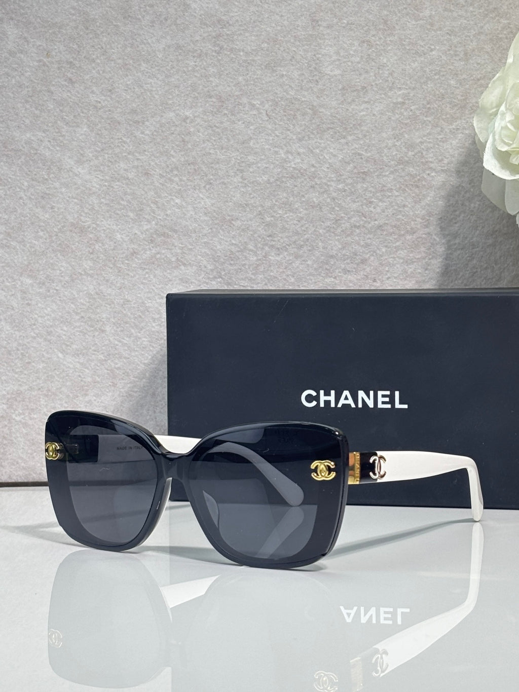 Chanel sunglasses with dark blue frames and white temples, gradient lenses