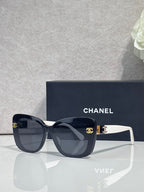 Chanel sunglasses with dark blue frames and white temples, gradient lenses