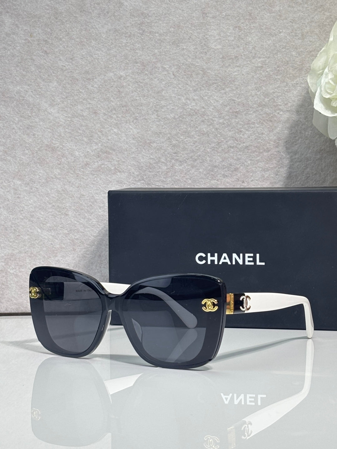 Chanel sunglasses with dark blue frames and white temples, gradient lenses