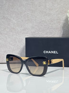 Chanel sunglasses with dark blue frames and beige temples, gradient lenses