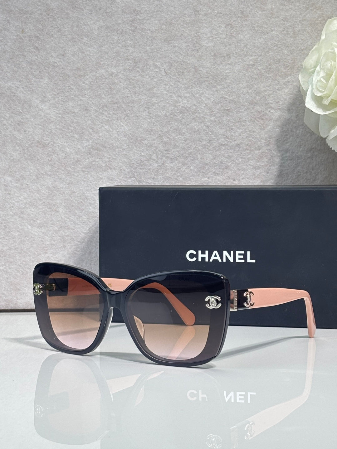 Chanel sunglasses with dark blue square frames and gradient brown lenses