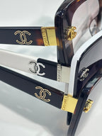 Chanel sunglasses close-up: dark temples with gold Chanel logo and logo accents