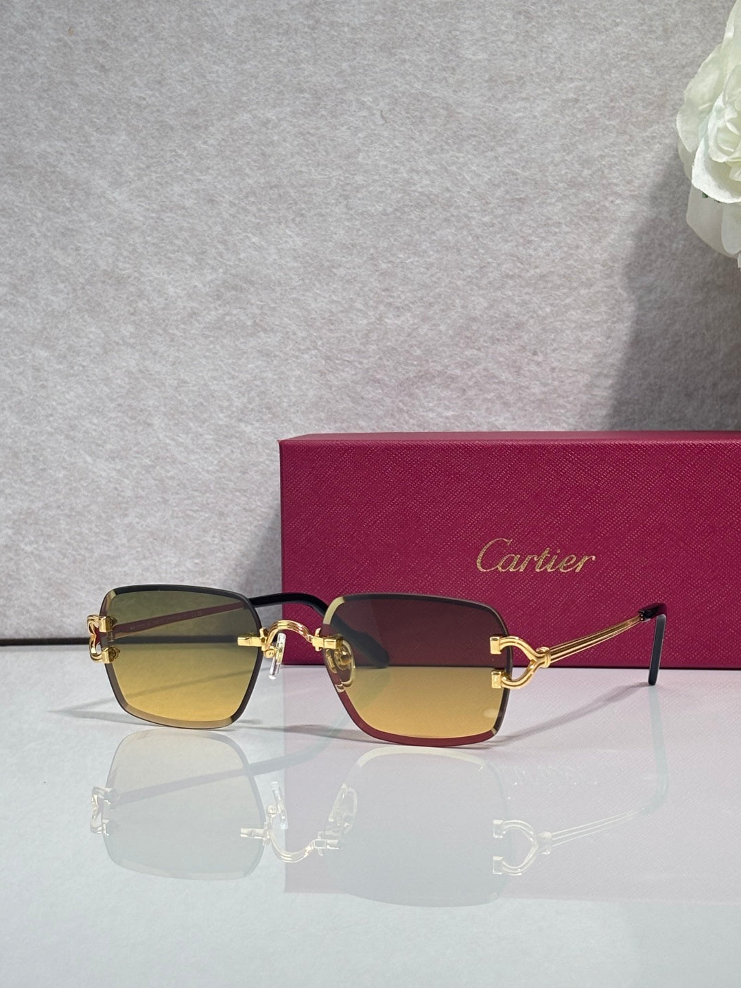 Cartier acetate eyeglasses with burgundy frame, dark lenses, and gold-tone hardware