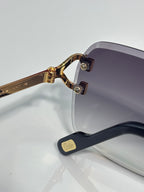 Cartier eyeglass frame side view with gold-tone metal arm and dark-tinted lens