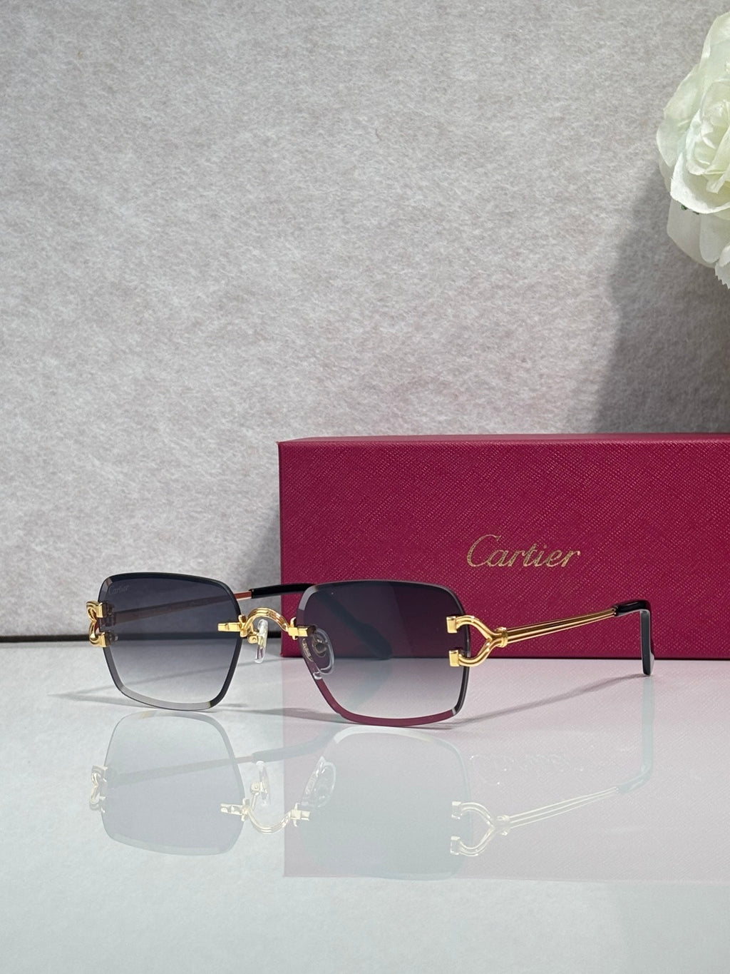 Cartier acetate eyeglasses with navy frame, purple-tinted lenses, and gold-tone hinges