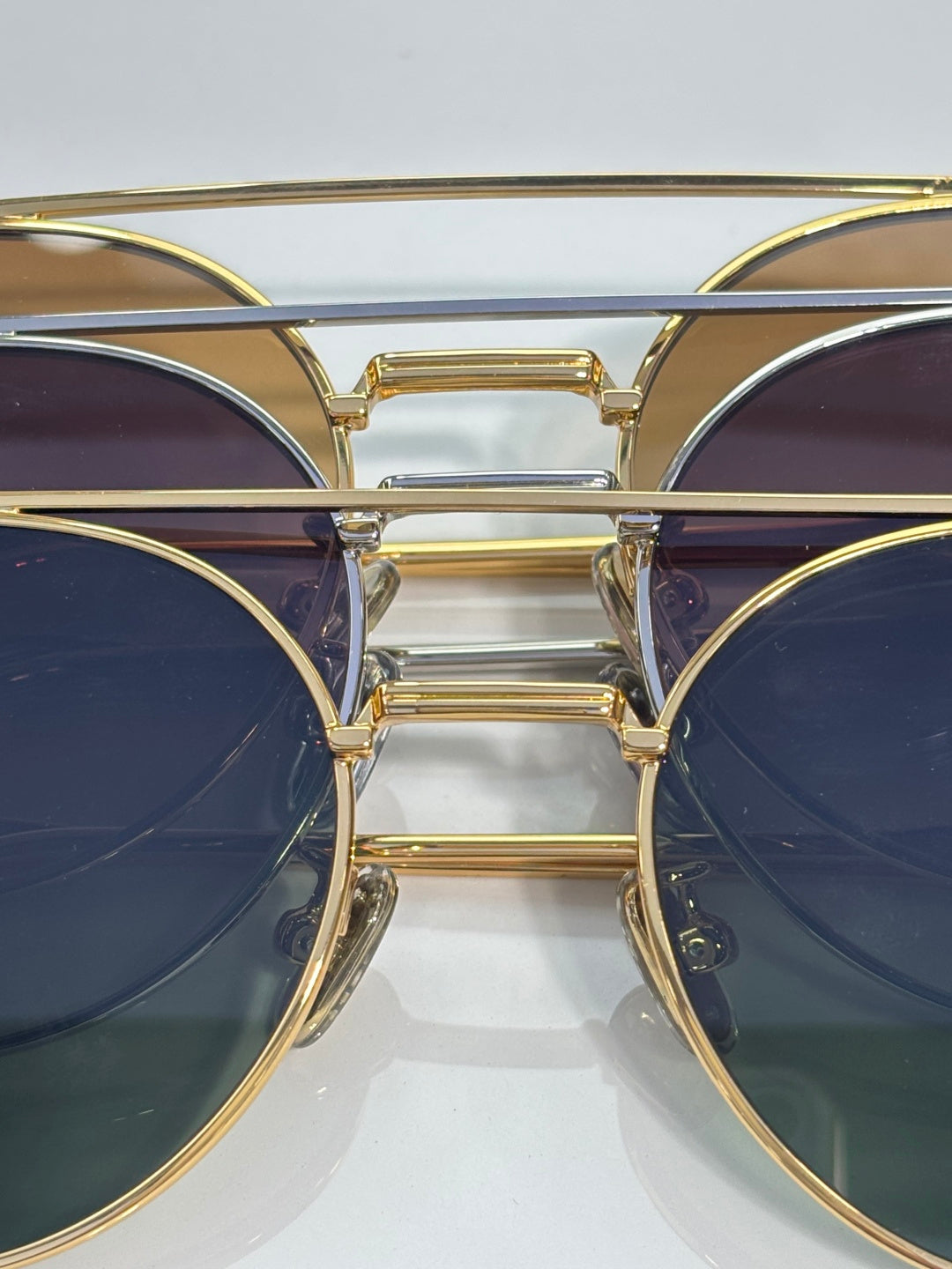 Dior sunglasses close-up: gold metal bridge with dark round lenses