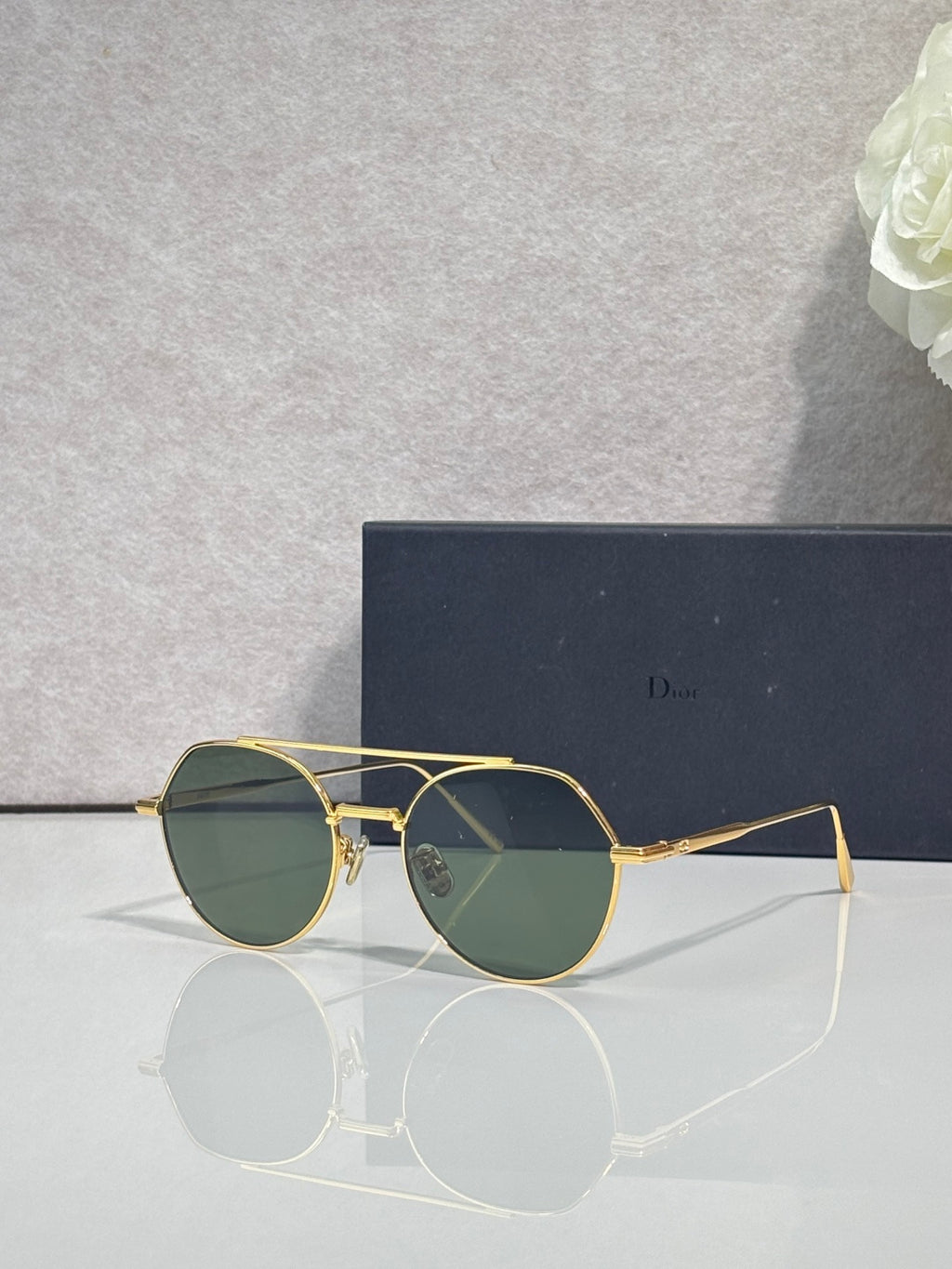 Dior sunglasses with gold metal frame and green-tinted round lenses