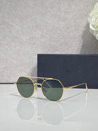 Dior sunglasses with gold metal frame and green-tinted round lenses