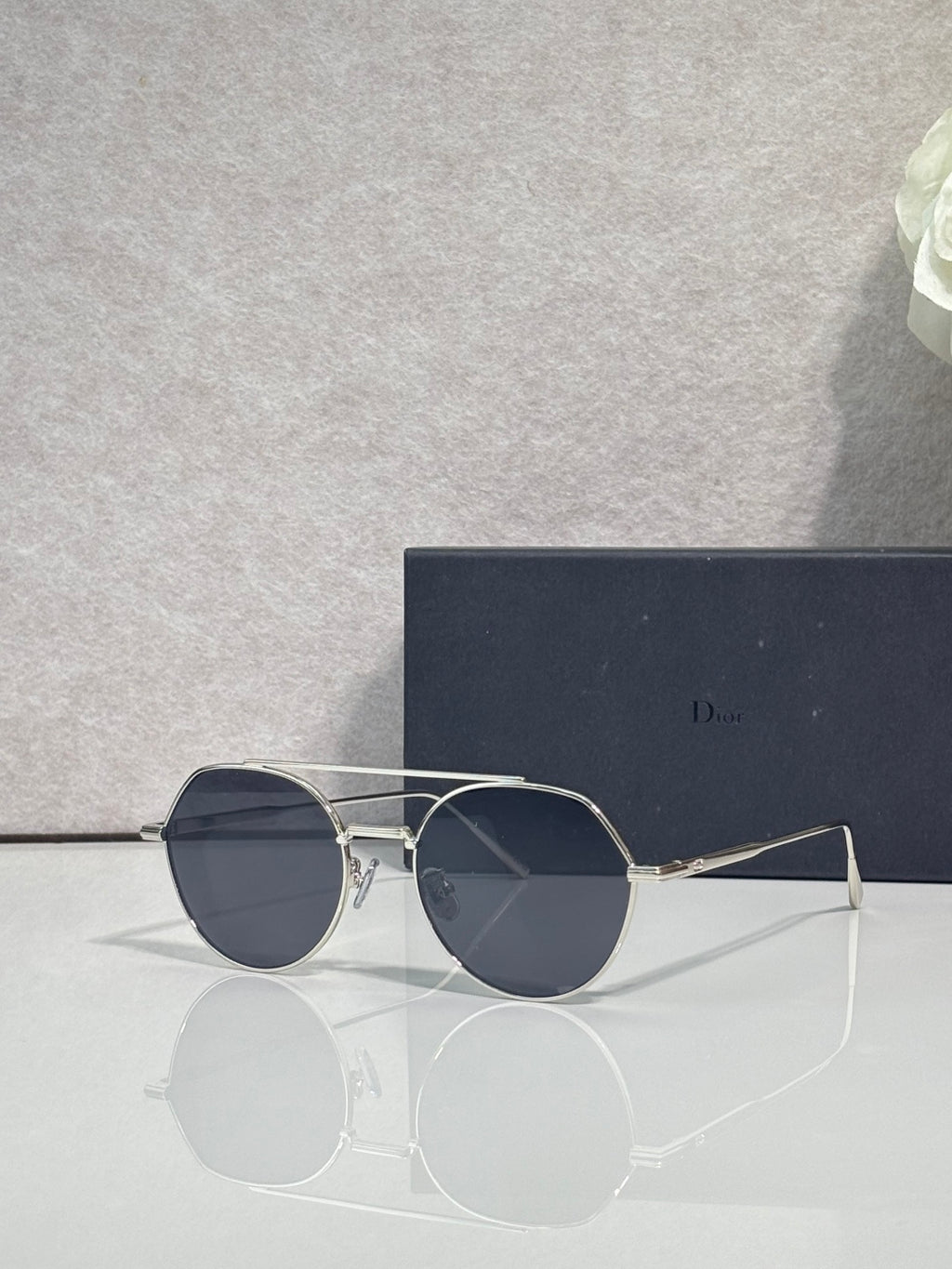 Dior sunglasses with silver metal frame and navy-tinted round lenses