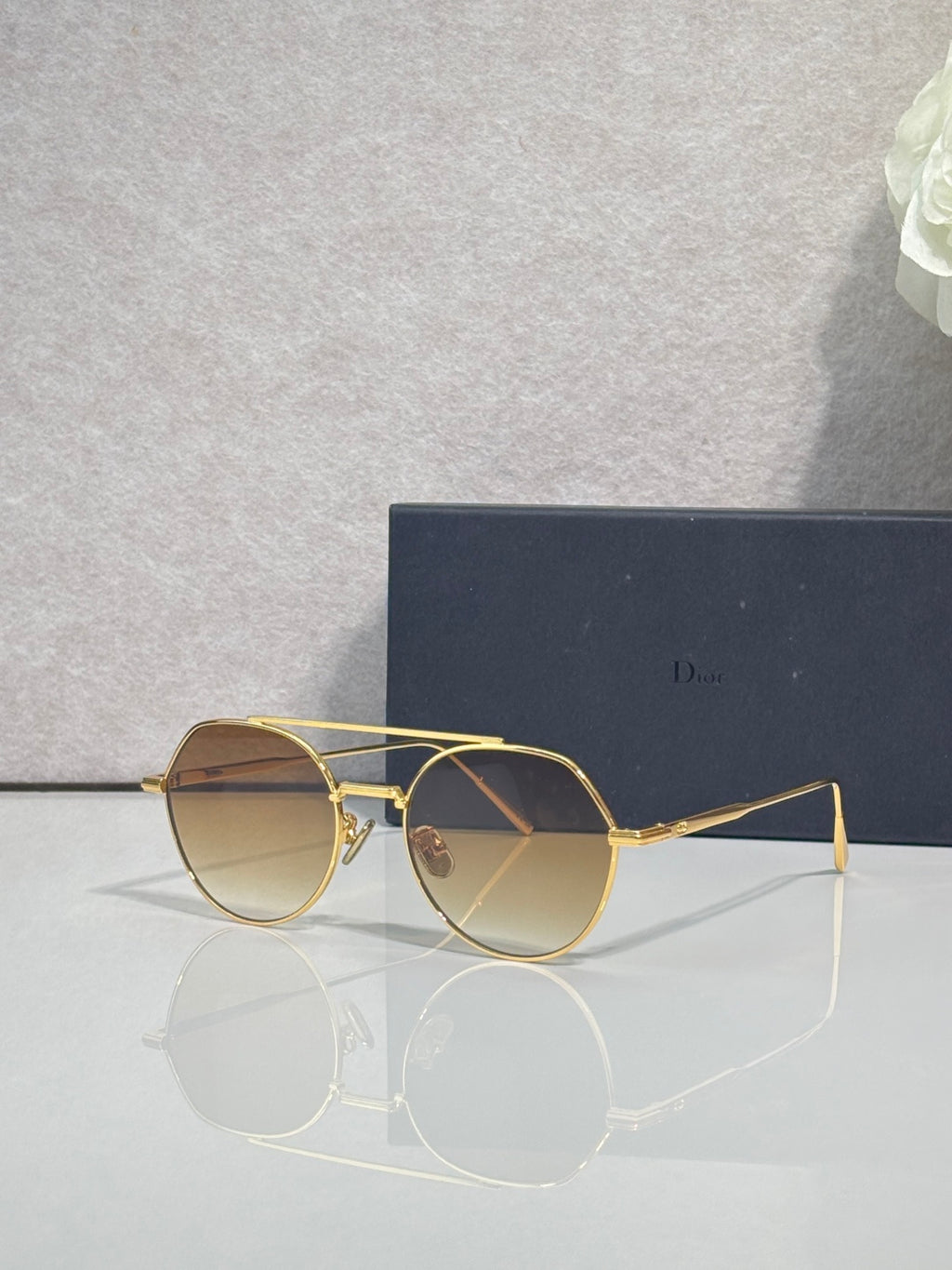 Dior sunglasses with gold metal frame and warm brown round lenses