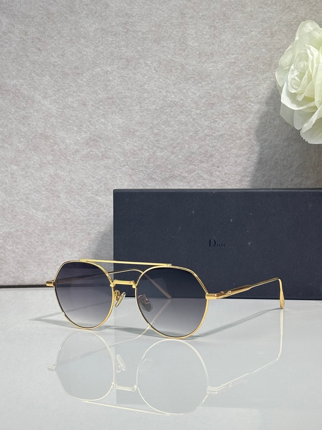 Dior sunglasses with gold metal frame and dark blue round lenses