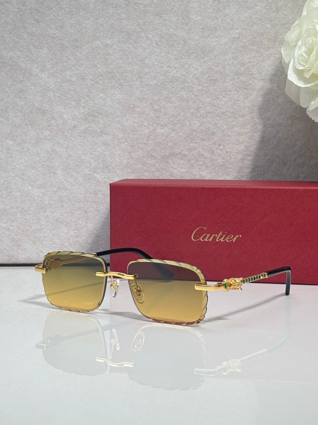Cartier glasses with gold metal frame and amber tinted lenses, slim black temple arms