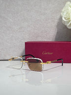 Cartier glasses with gold metal frame, dark tinted lenses, and thin black temples