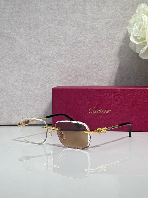 Cartier glasses with gold metal frame, dark tinted lenses, and thin black temples