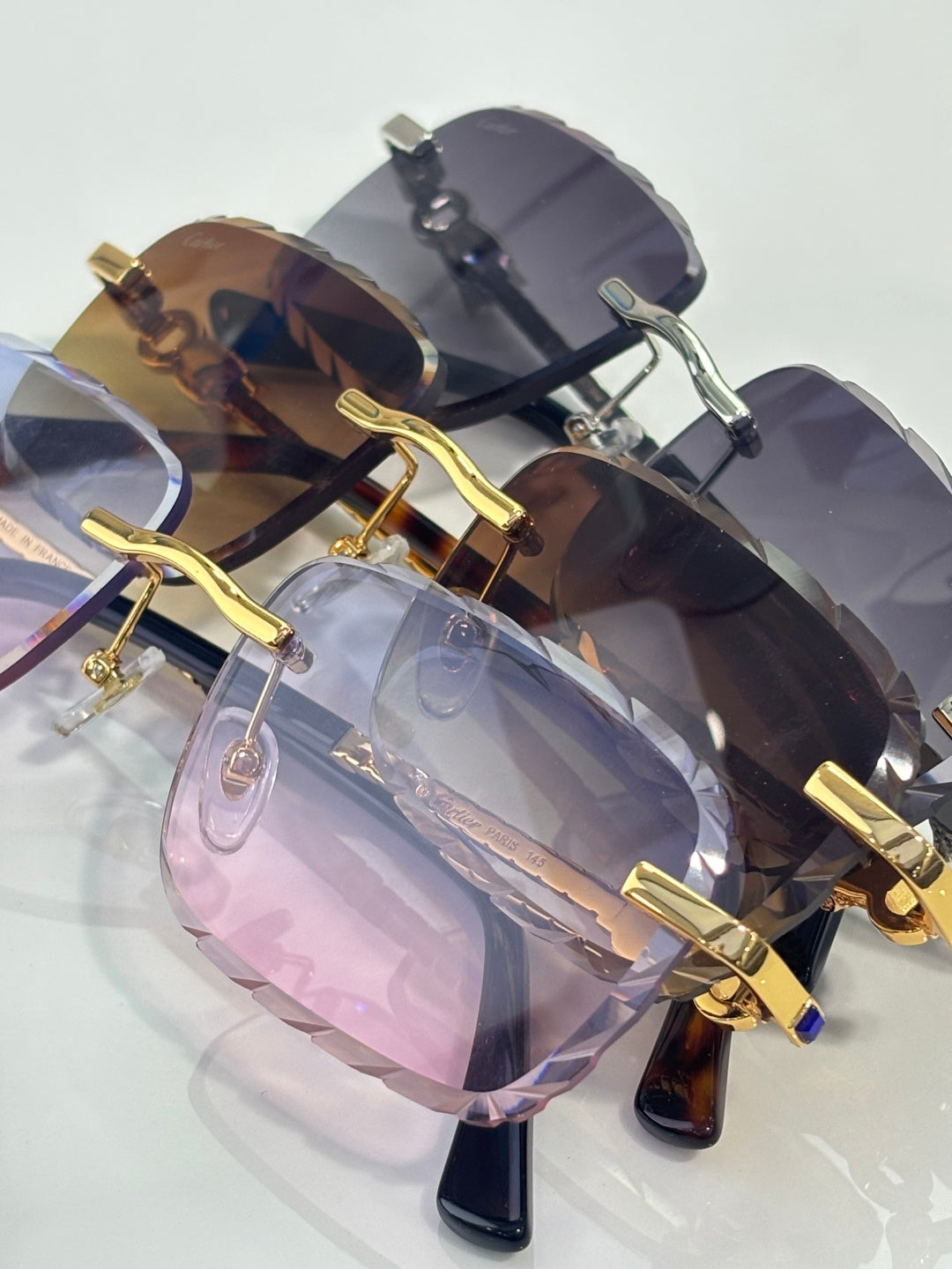Cartier glasses angled view with gold frame accents and dark tinted lenses