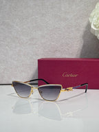 Cat-eye glasses with dark frame and gold-tone accents, tinted lenses and ornate temple piece