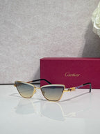 Cat-eye glasses with black frame and gold-tone temples, tinted lenses and decorative hinge detail