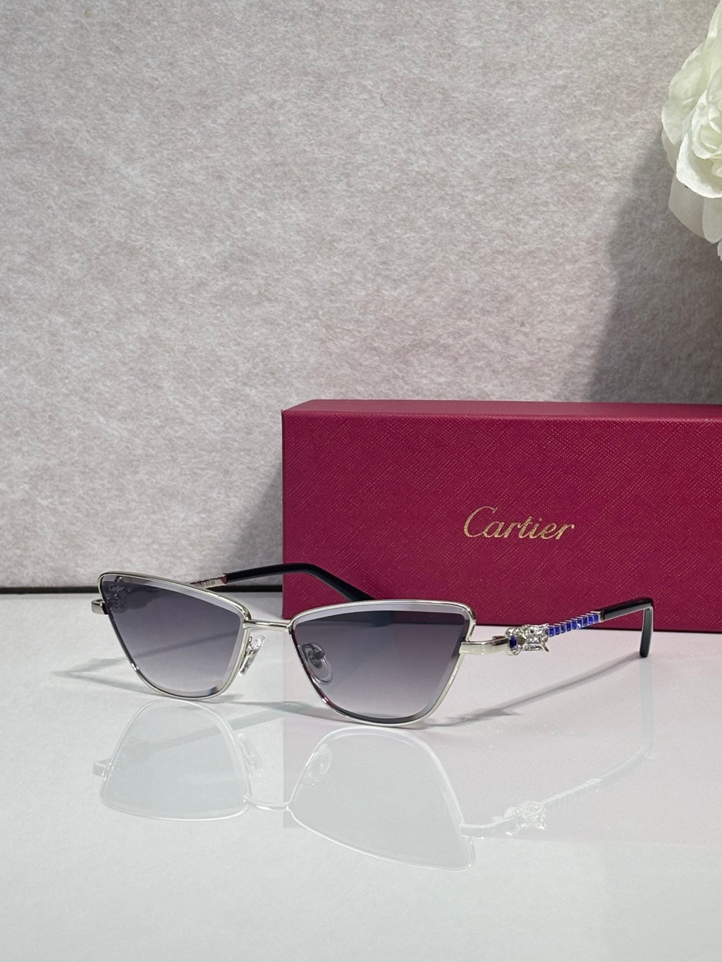 Cat-eye glasses with black frame and silver-tone temples, dark tinted lenses and jeweled accents