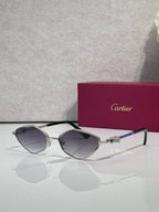 Cartier glasses with dark frame, dark lenses, and gold temple accents.