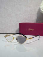 Cartier glasses with gold-tone frame, dark gray lenses, and black temples.