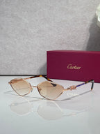 Cartier glasses with rose-gold tone frame and amber lenses, with decorative temple.