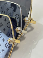 Louis Vuitton gold-tone sunglasses hinge detail with flower charm and patterned lens