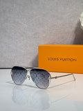 Louis Vuitton sunglasses with dark blue monogram-pattern lenses and gold metal frame
