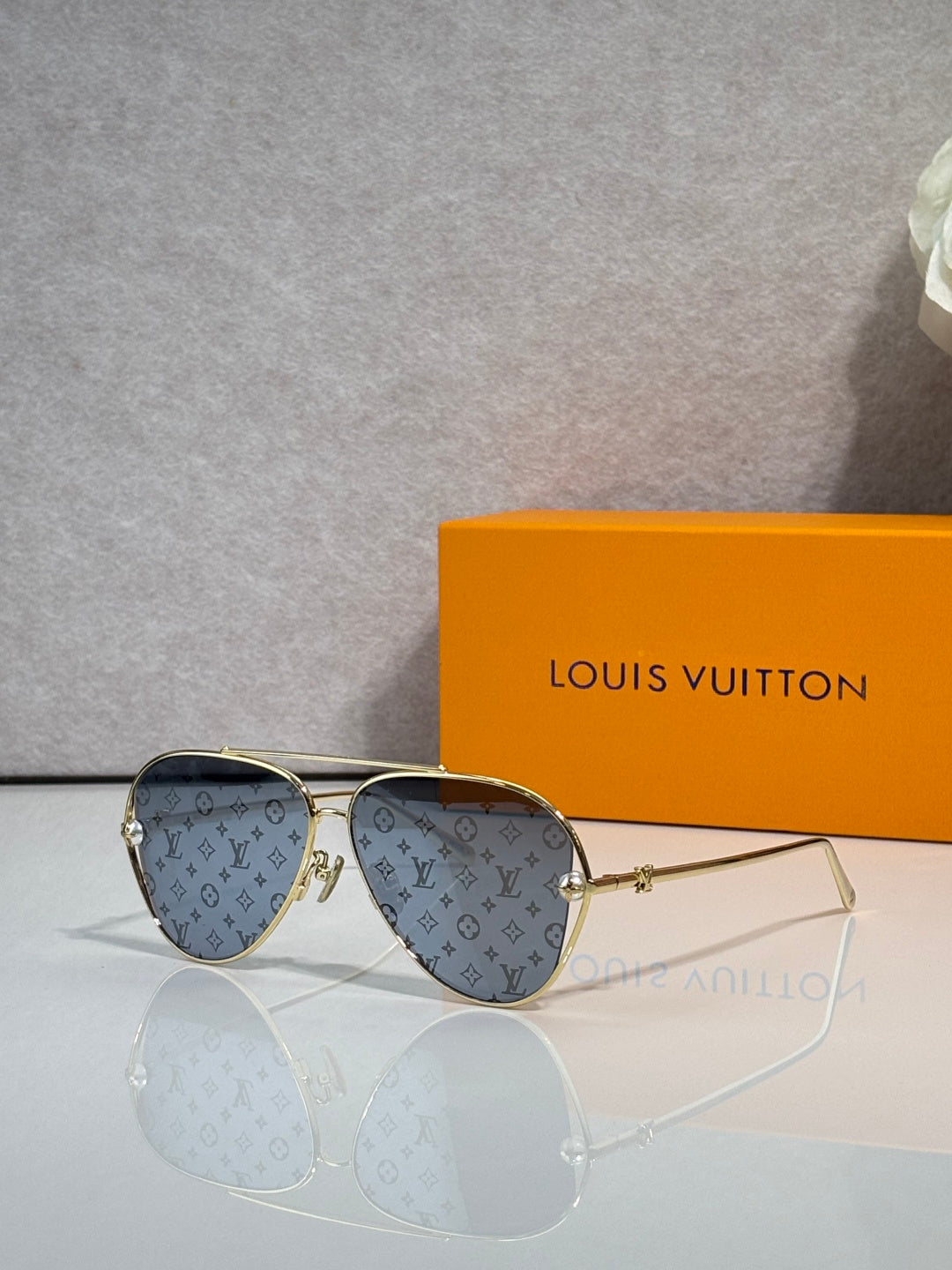 Louis Vuitton sunglasses with blue monogram-pattern lenses and gold-tone metal frame
