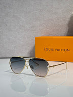 Louis Vuitton sunglasses with dark blue lenses and gold metal frame, angled view