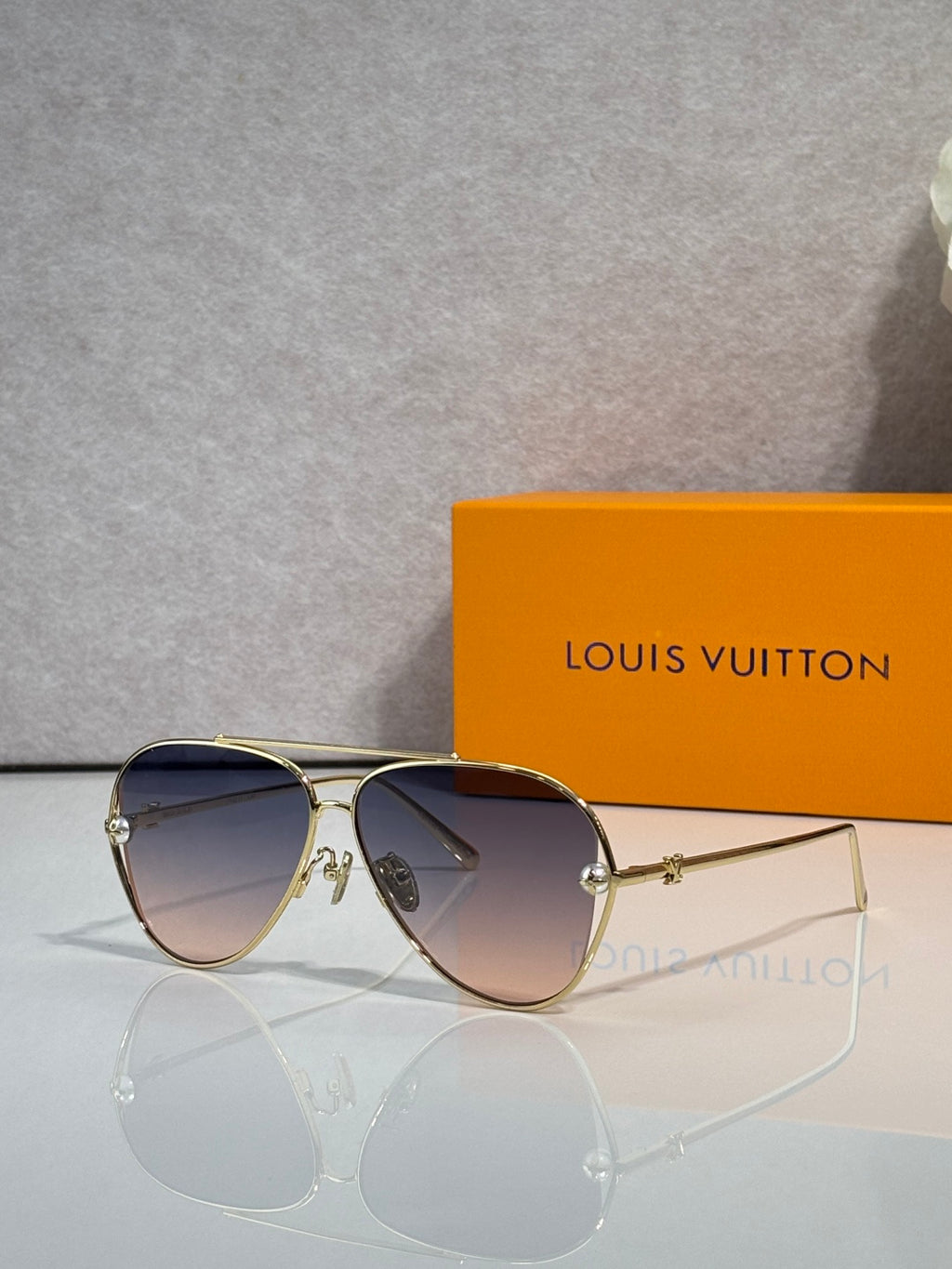 Louis Vuitton sunglasses with dark blue lenses and gold metal frame