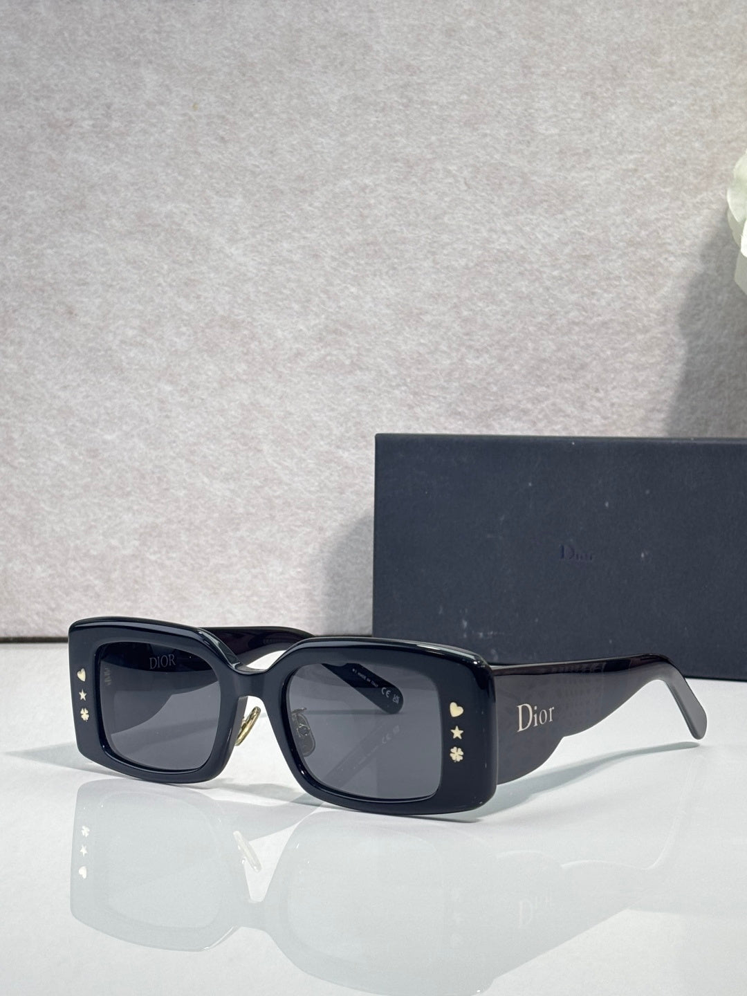 Dior rectangular sunglasses with dark lenses, navy frame, Dior logo on side temple
