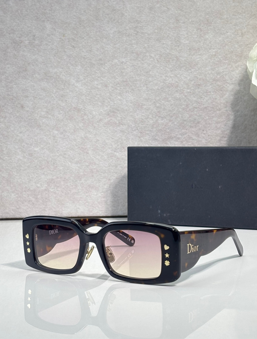 Dior rectangular eyeglasses with clear-to-light lenses, dark navy frame and gold details