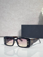 Dior rectangular eyeglasses with clear-to-light lenses, dark navy frame and gold details