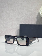 Dior rectangular sunglasses with dark lenses, navy frame, gold star motifs on temples