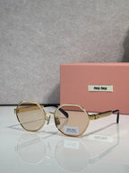 MiuMiu round sunglasses with gold frame and amber tinted lenses
