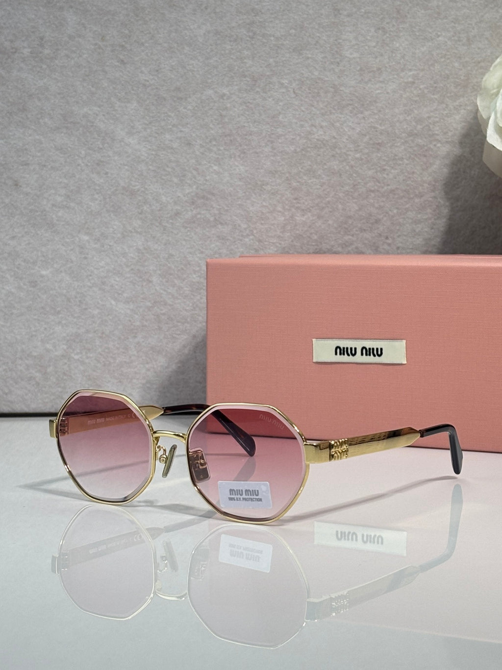 MiuMiu round sunglasses with gold frame and rose tinted lenses