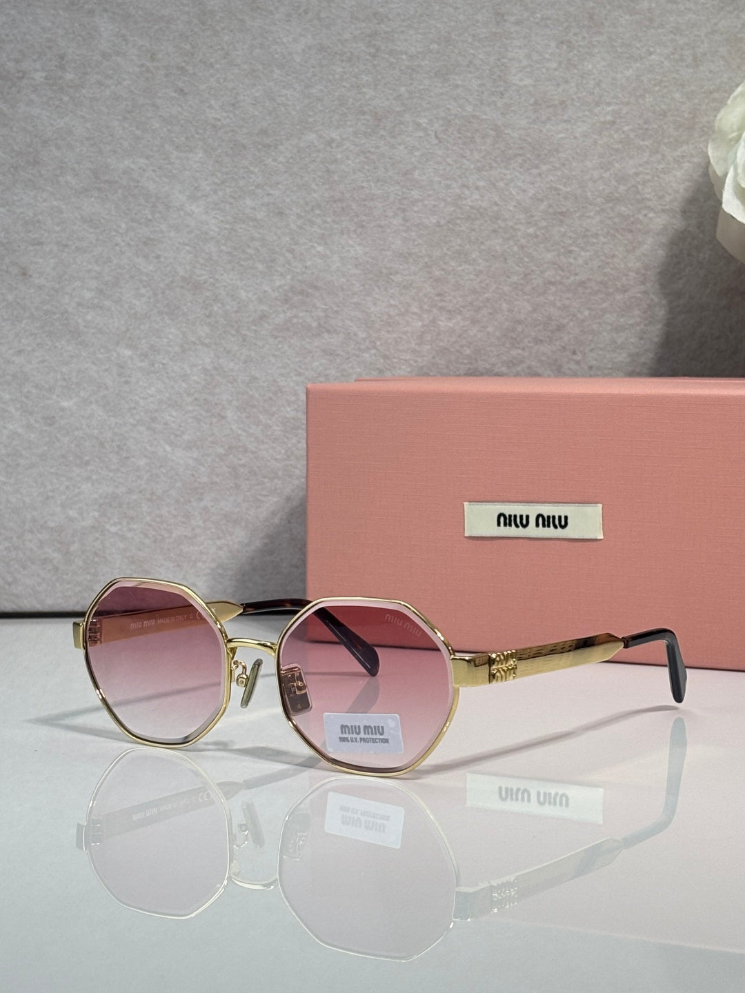 MiuMiu round sunglasses with gold frame and rose tinted lenses