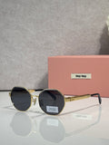 MiuMiu round sunglasses with gold frame and dark gray tinted lenses