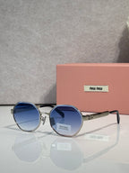 MiuMiu round sunglasses with navy tinted lenses and silver frame